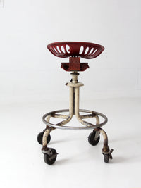 vintage industrial rolling stool with cast iron tractor seat