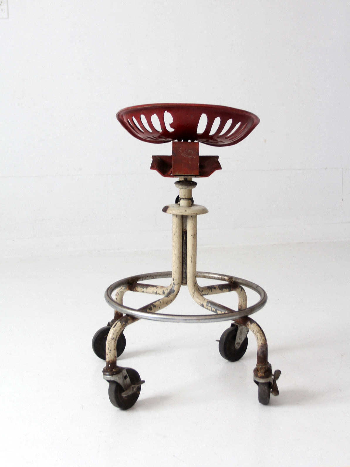 vintage industrial rolling stool with cast iron tractor seat