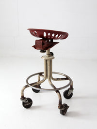 vintage industrial rolling stool with cast iron tractor seat