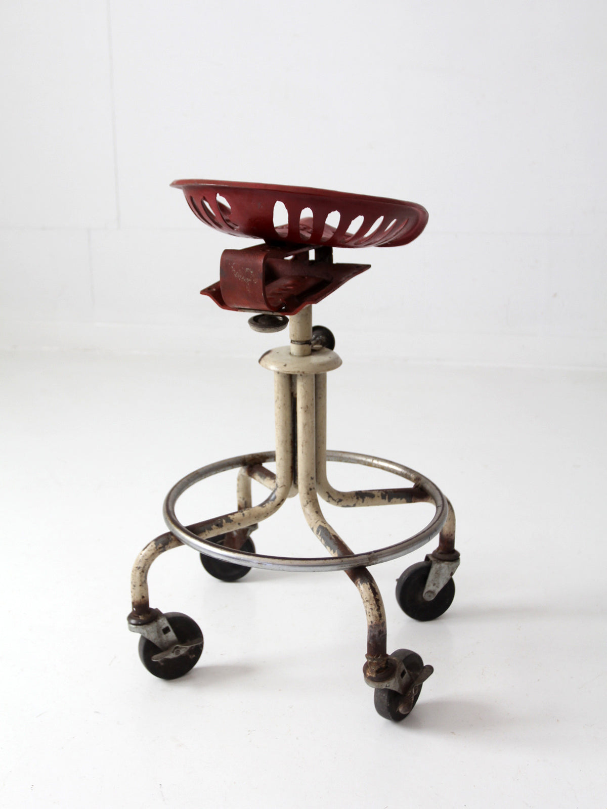 vintage industrial rolling stool with cast iron tractor seat