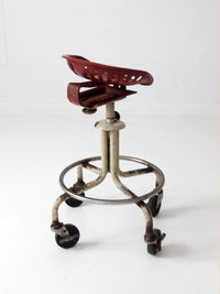 vintage industrial rolling stool with cast iron tractor seat