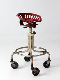 vintage industrial rolling stool with cast iron tractor seat