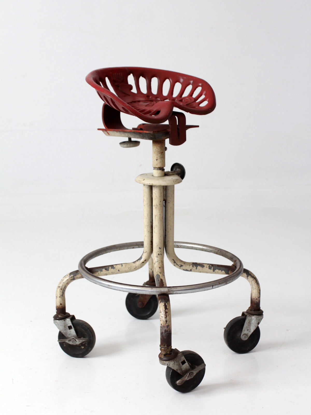 vintage industrial rolling stool with cast iron tractor seat