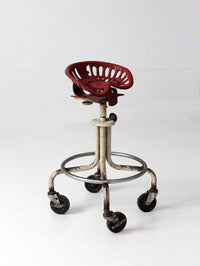 vintage industrial rolling stool with cast iron tractor seat