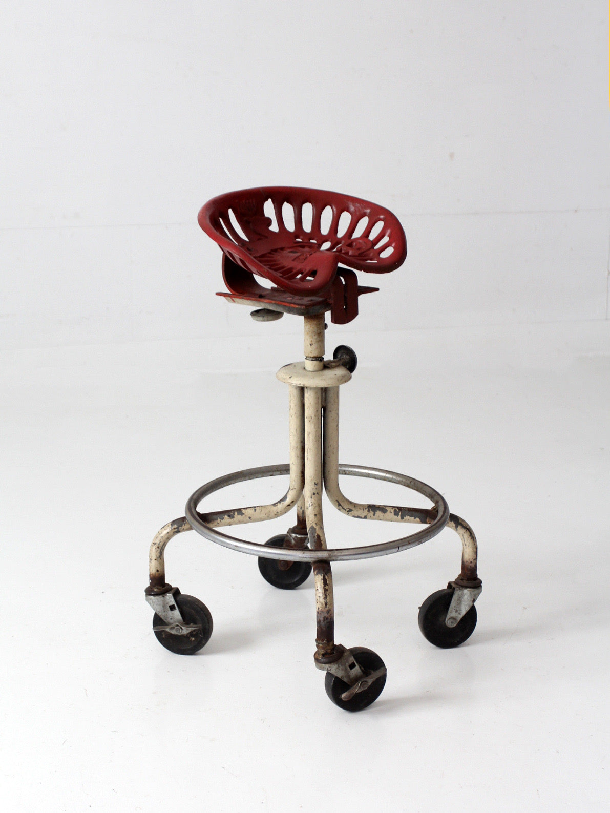 vintage industrial rolling stool with cast iron tractor seat