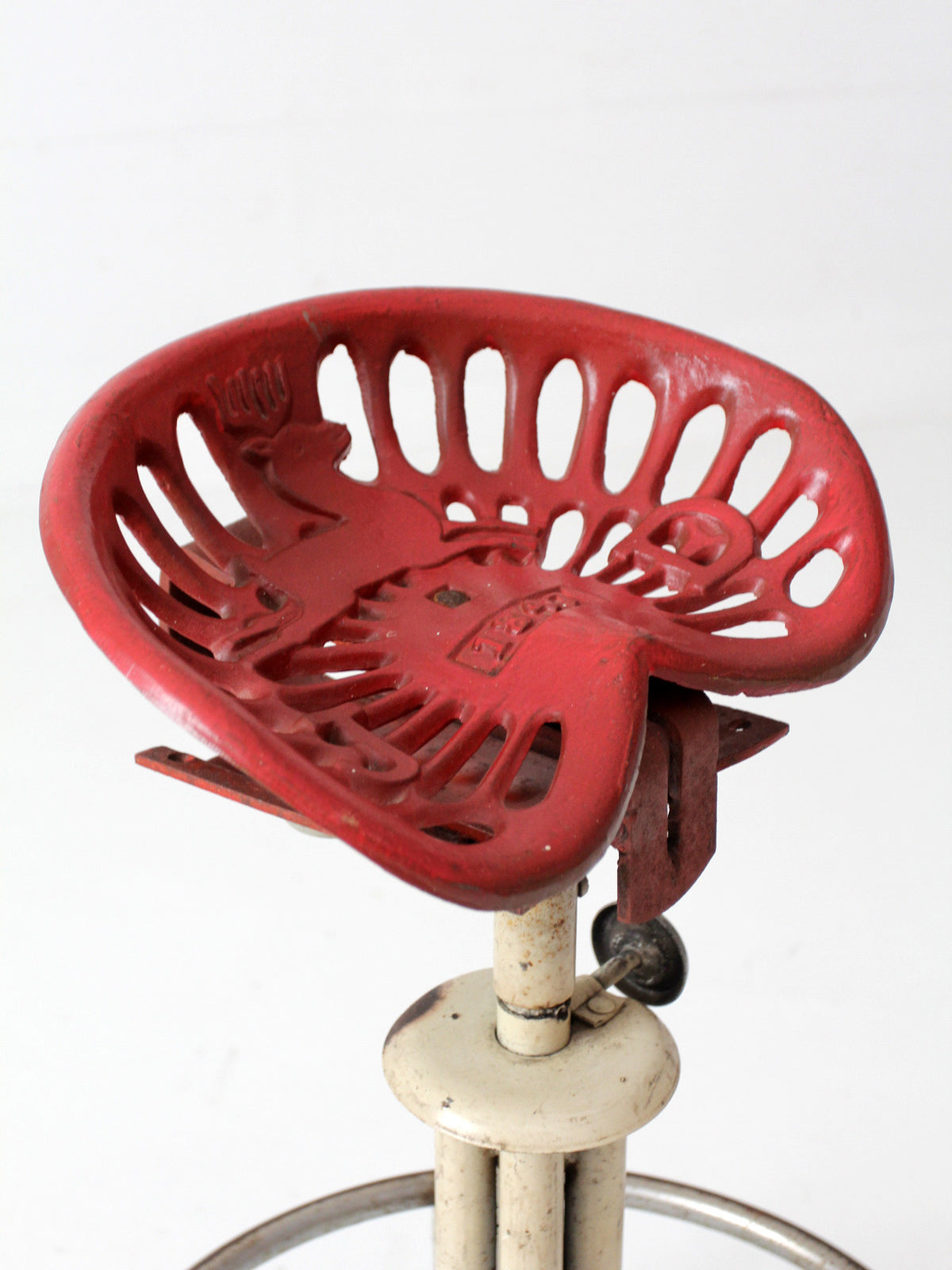 vintage industrial rolling stool with cast iron tractor seat