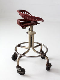 vintage industrial rolling stool with cast iron tractor seat