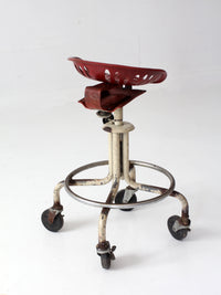 vintage industrial rolling stool with cast iron tractor seat