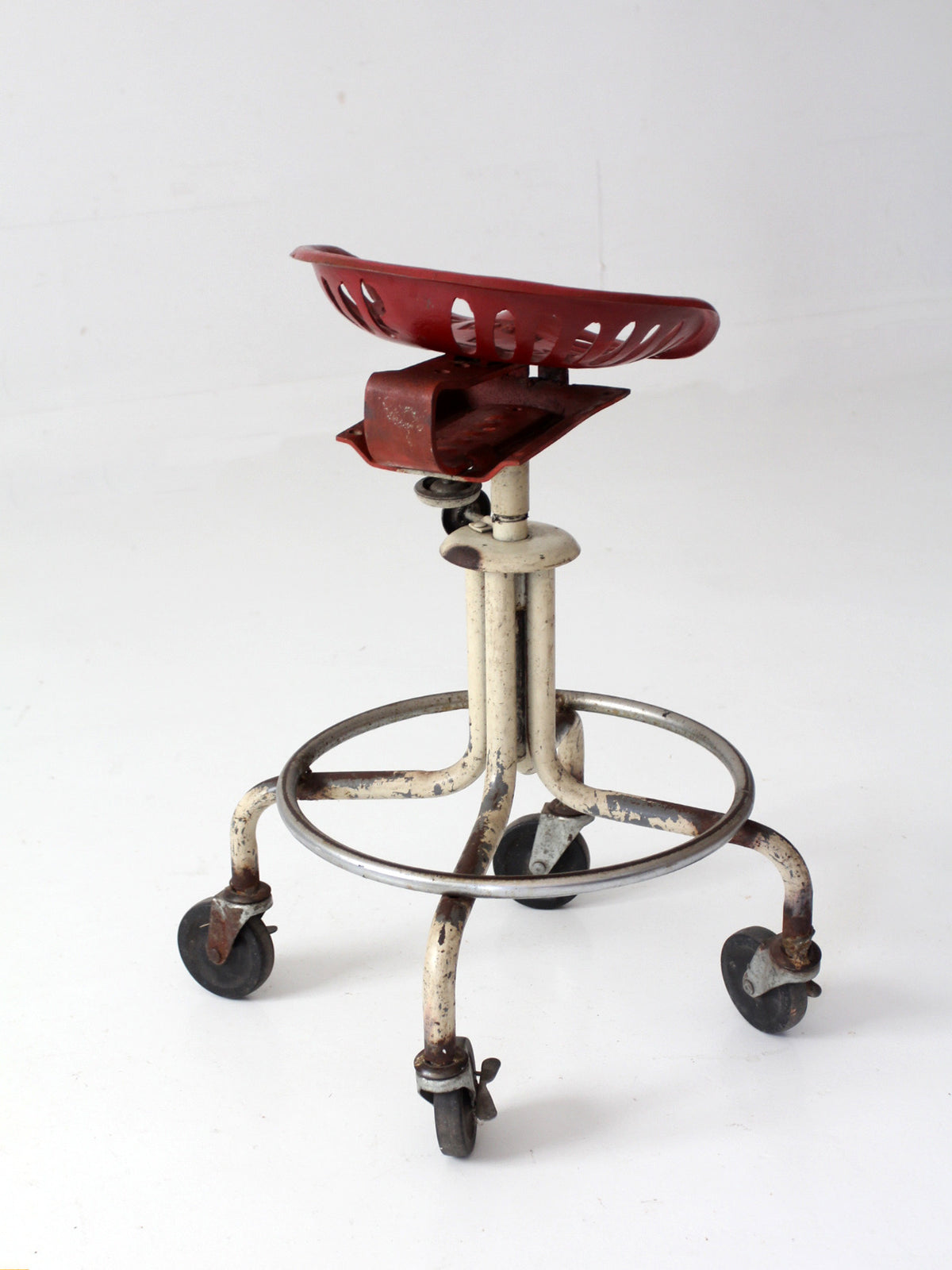 vintage industrial rolling stool with cast iron tractor seat