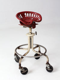 vintage industrial rolling stool with cast iron tractor seat