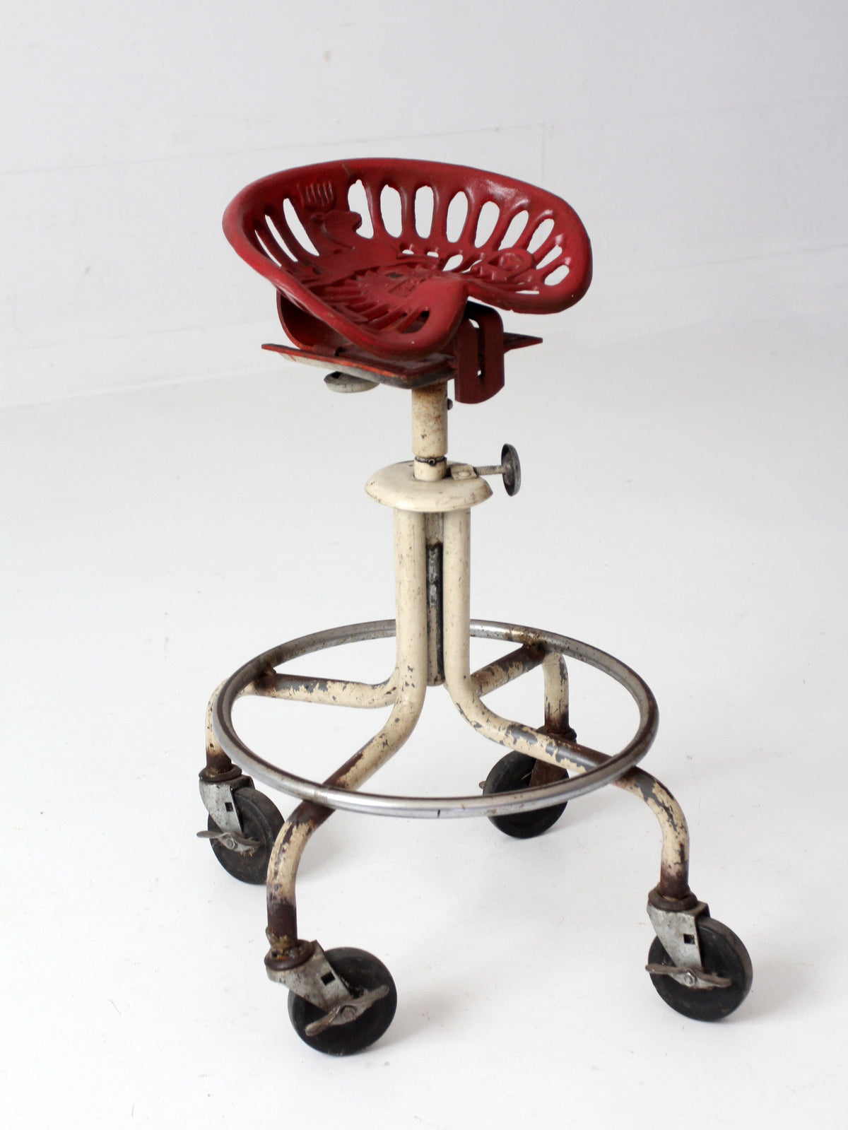 vintage industrial rolling stool with cast iron tractor seat