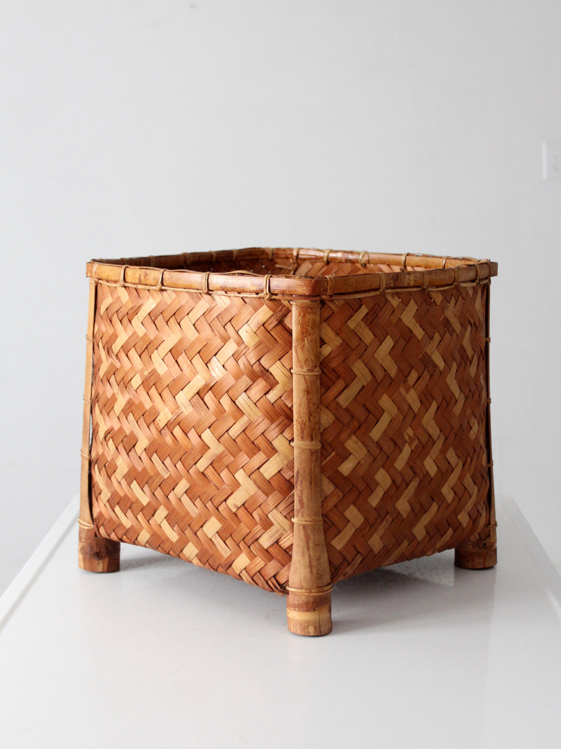 vintage geometric woven bamboo storage basket, circa 1970s