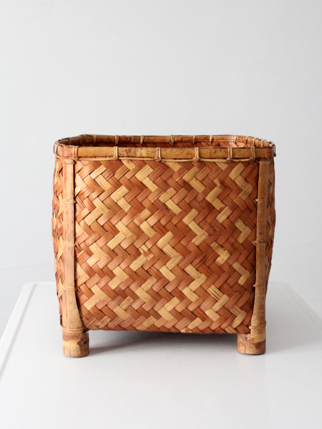 vintage geometric woven bamboo storage basket, circa 1970s