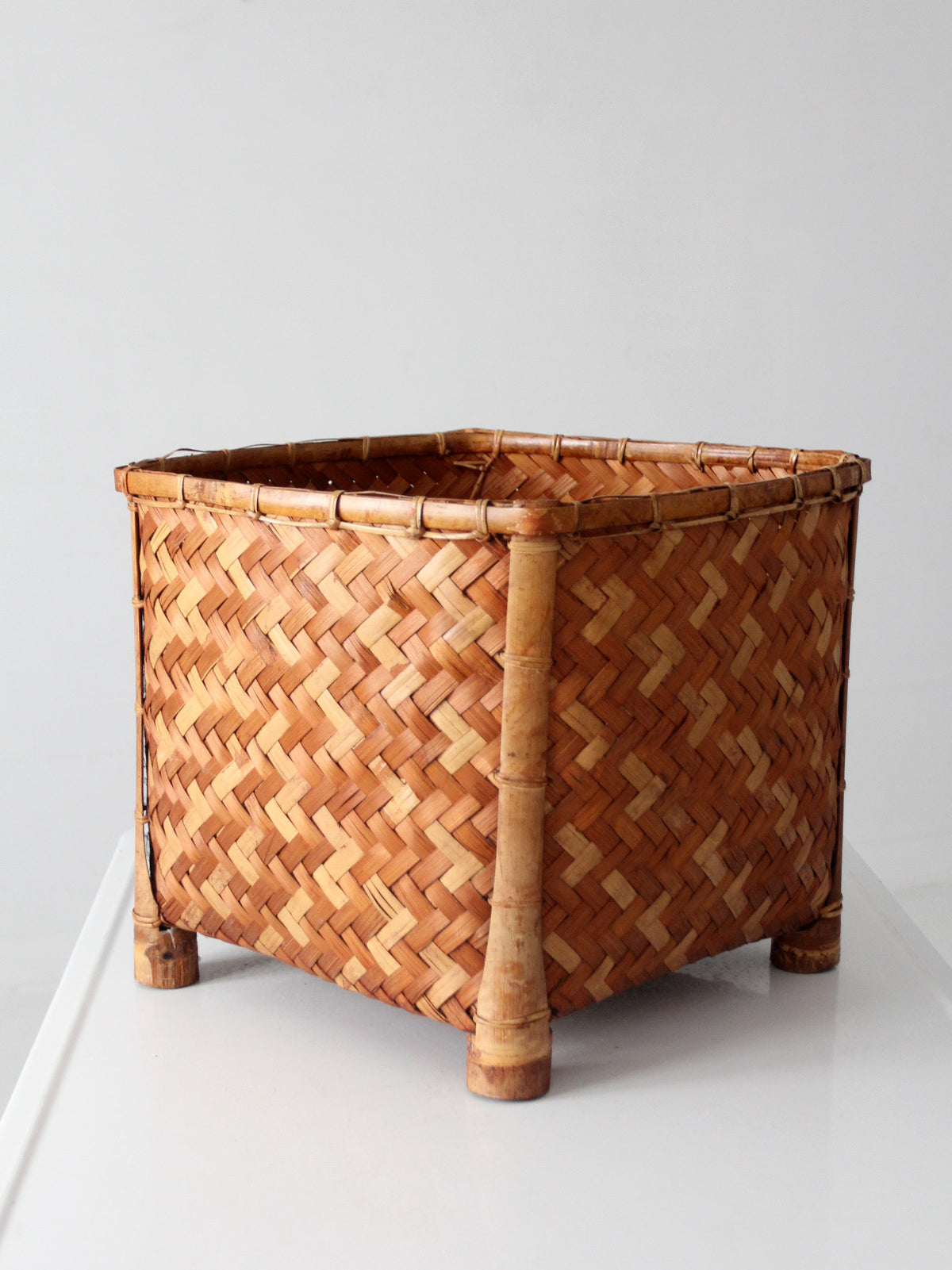 vintage geometric woven bamboo storage basket, circa 1970s