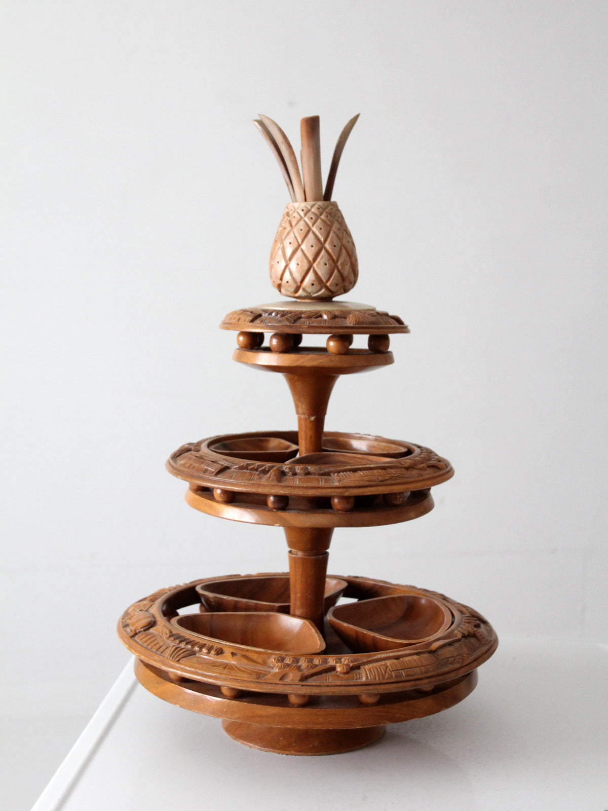 mid-century carved wood tiered lazy Susan with pineapple finial