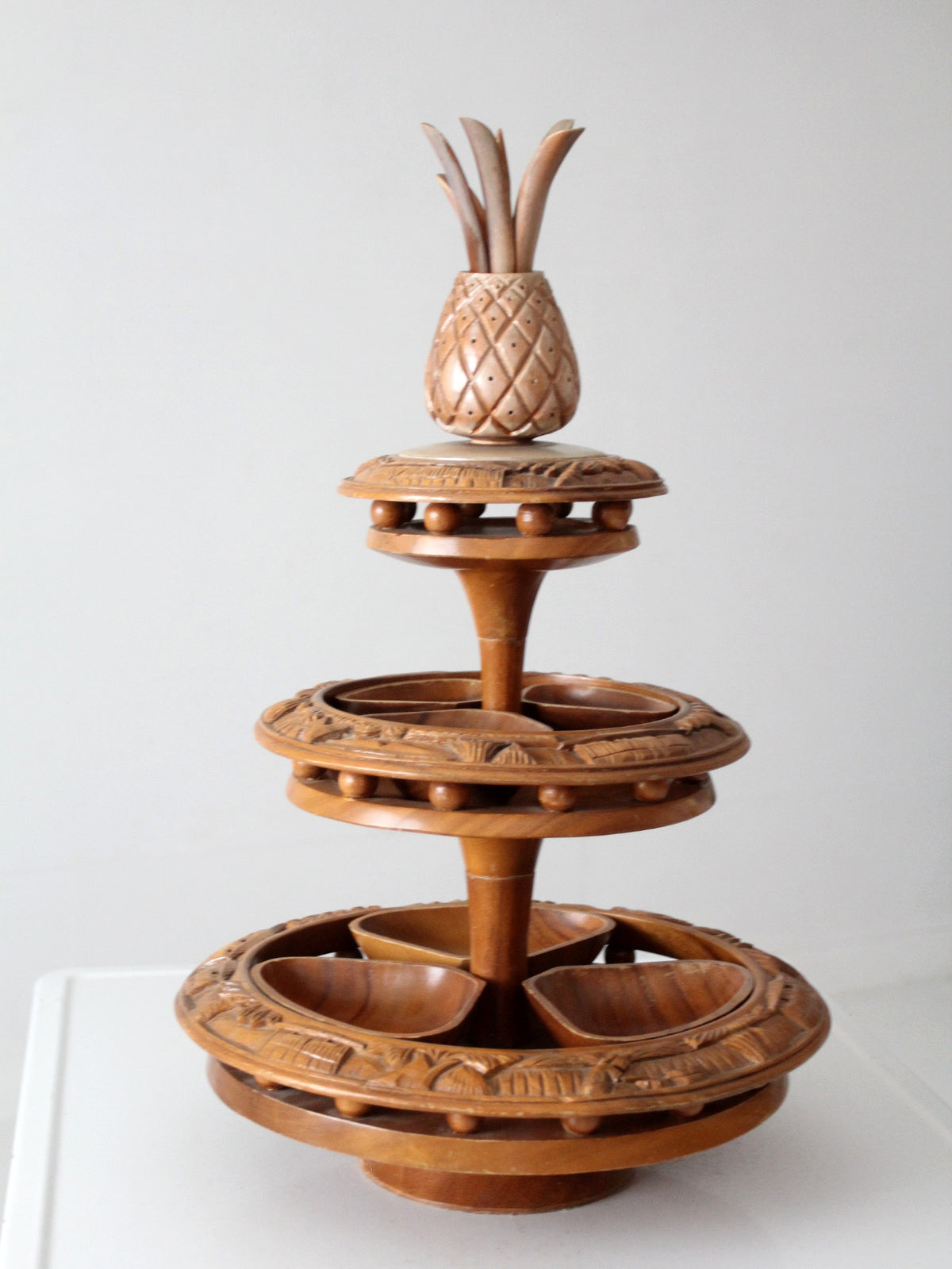 mid-century carved wood tiered lazy Susan with pineapple finial