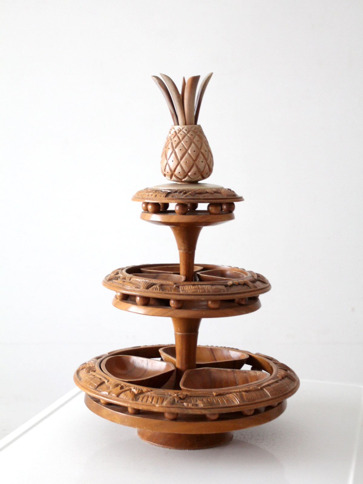 mid-century carved wood tiered lazy Susan with pineapple finial