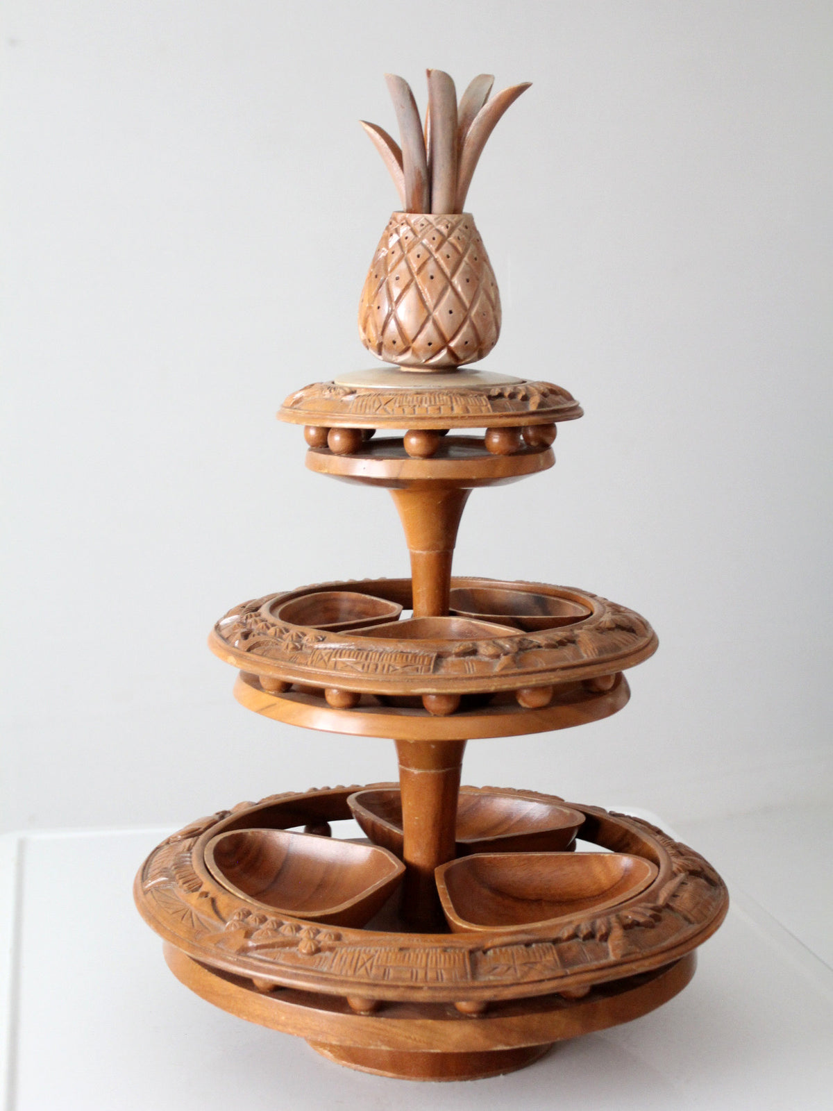 mid-century carved wood tiered lazy Susan with pineapple finial