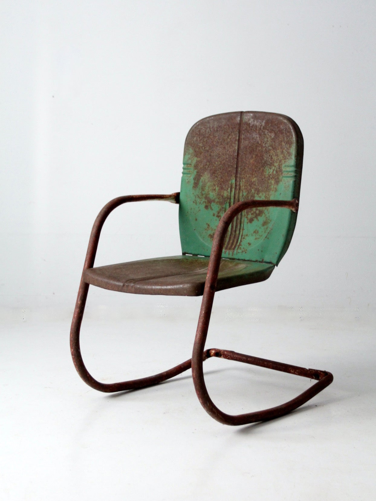 mid-century metal patio chair with cantilever frame