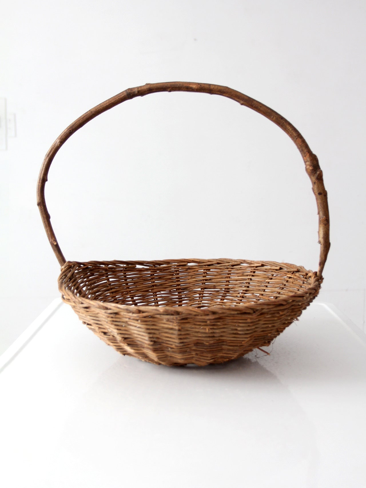 antique willow gathering basket with branch handle