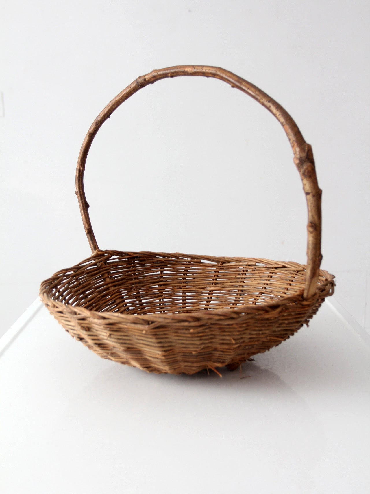 antique willow gathering basket with branch handle