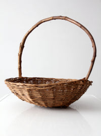 antique willow gathering basket with branch handle