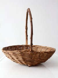antique willow gathering basket with branch handle