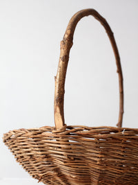 antique willow gathering basket with branch handle