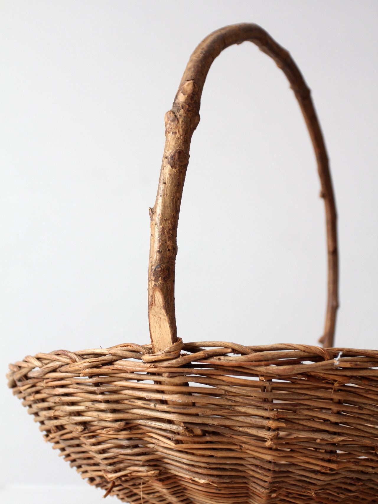 antique willow gathering basket with branch handle