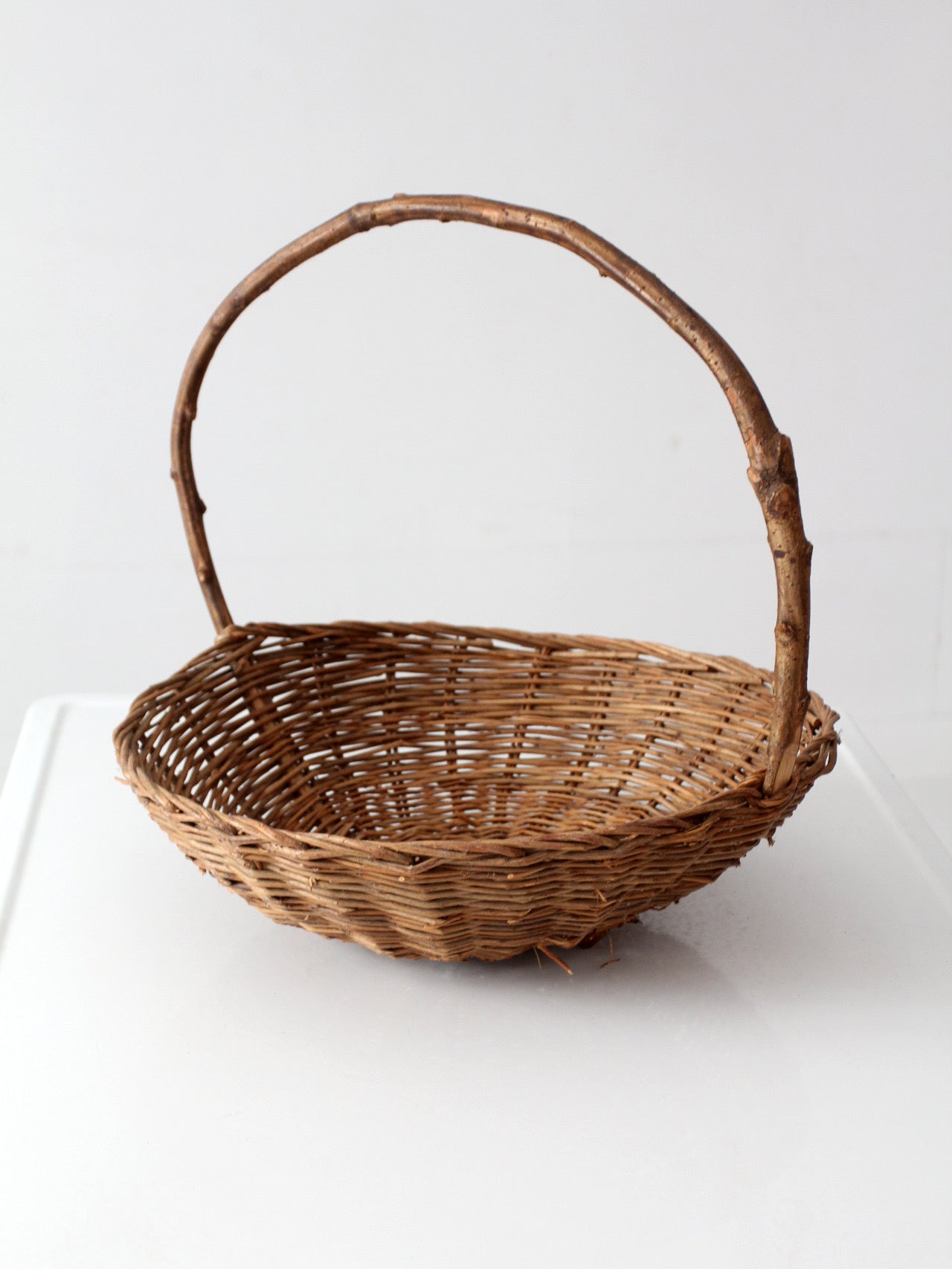 antique willow gathering basket with branch handle