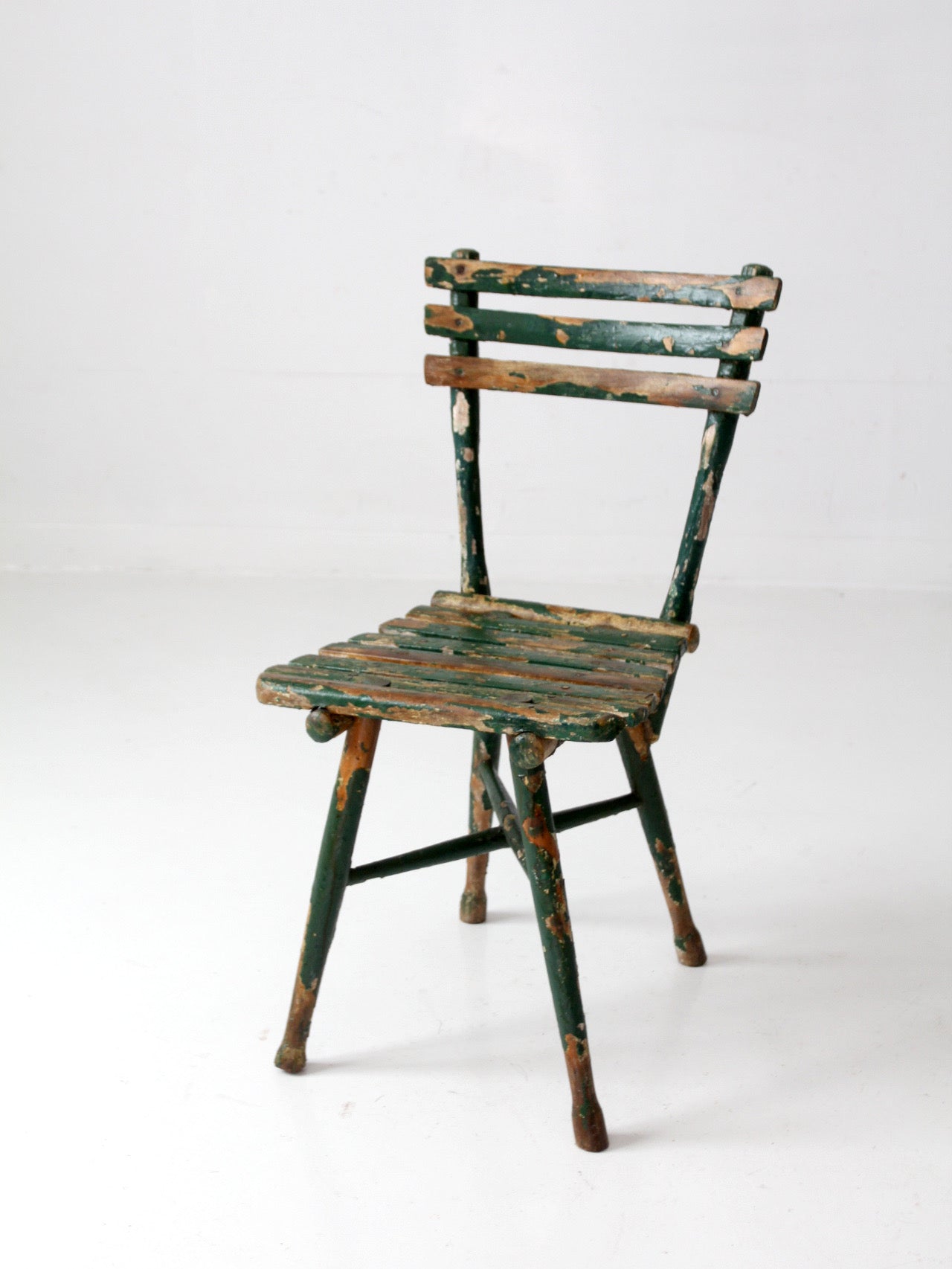 antique green painted rustic Adirondack chair