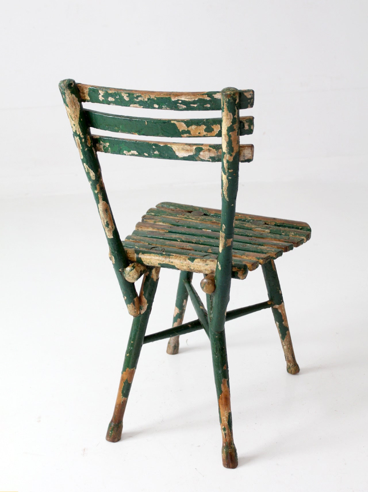 antique green painted rustic Adirondack chair