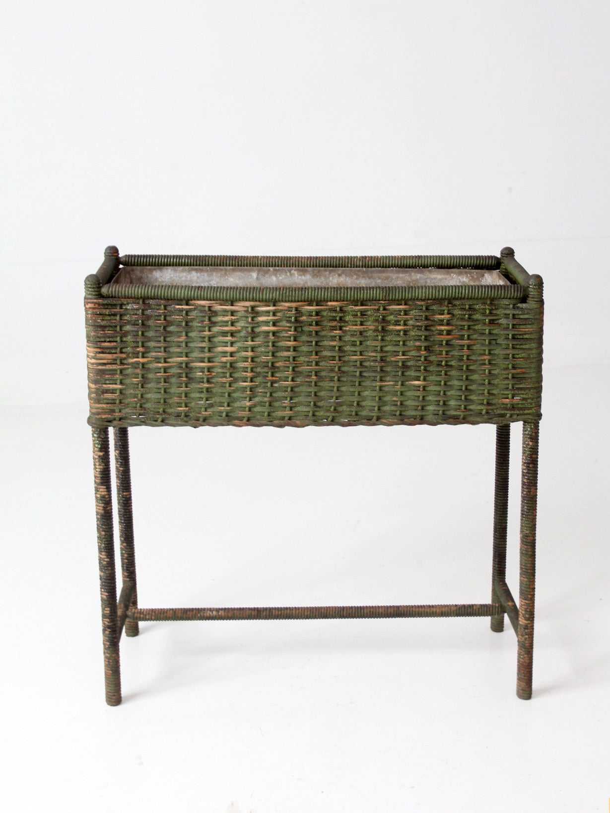 antique green painted wicker jardinière planter with metal liner