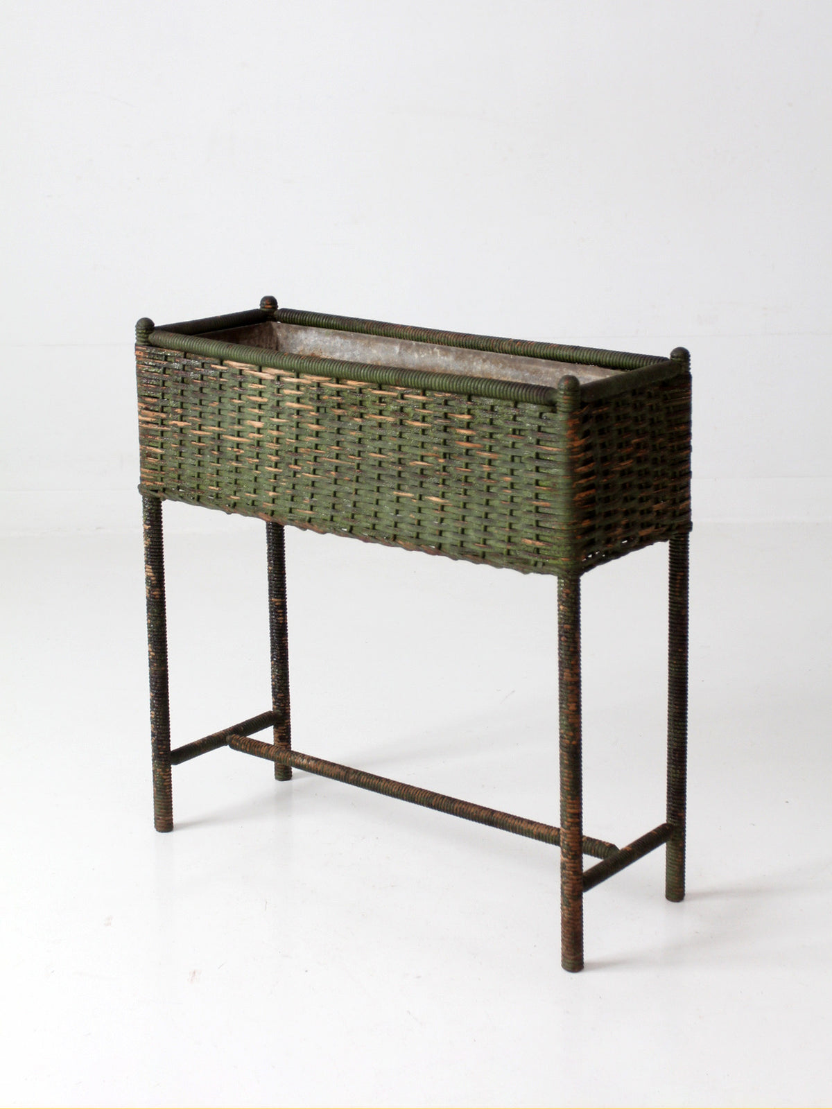 antique green painted wicker jardinière planter with metal liner