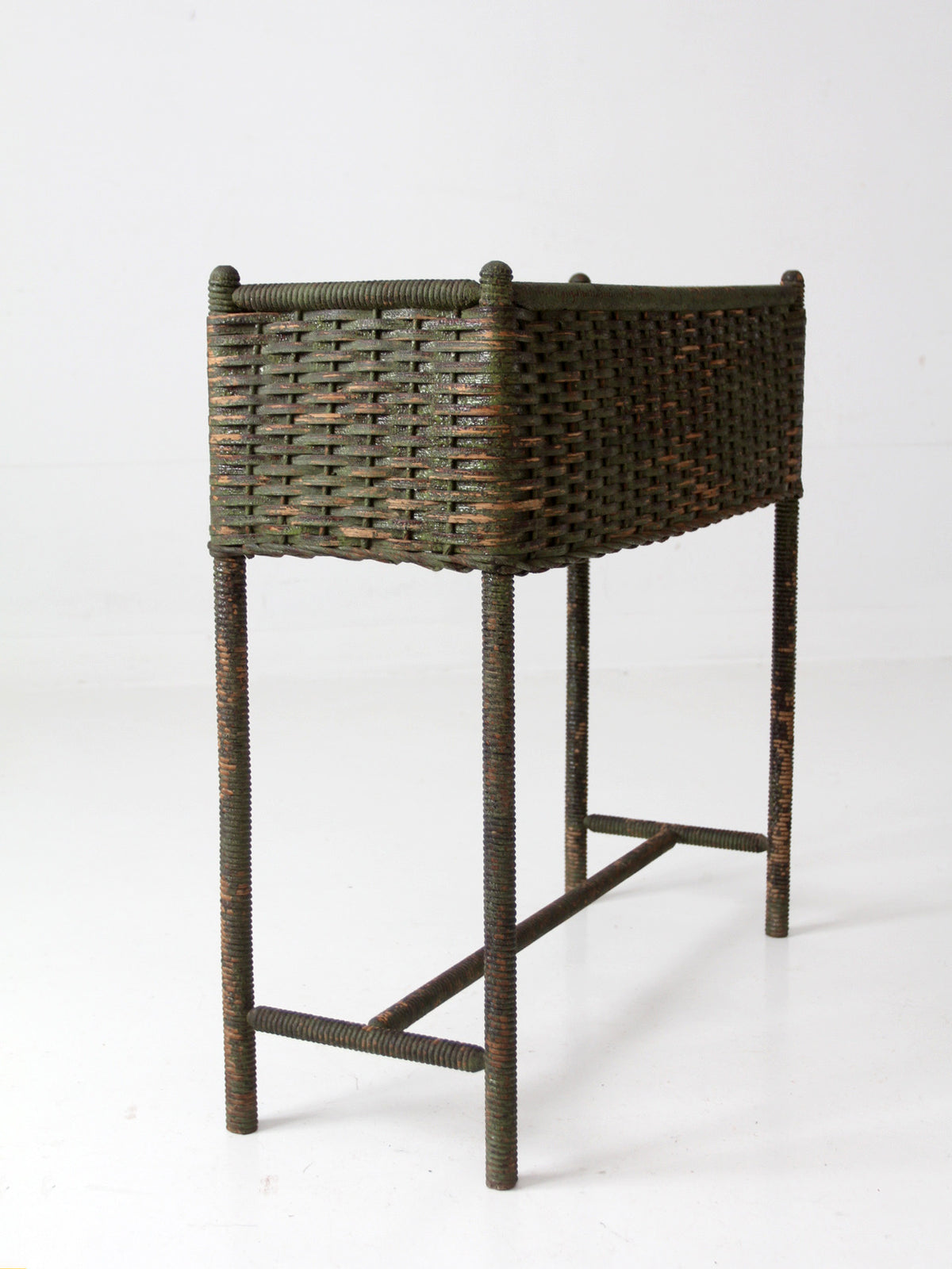 antique green painted wicker jardinière planter with metal liner