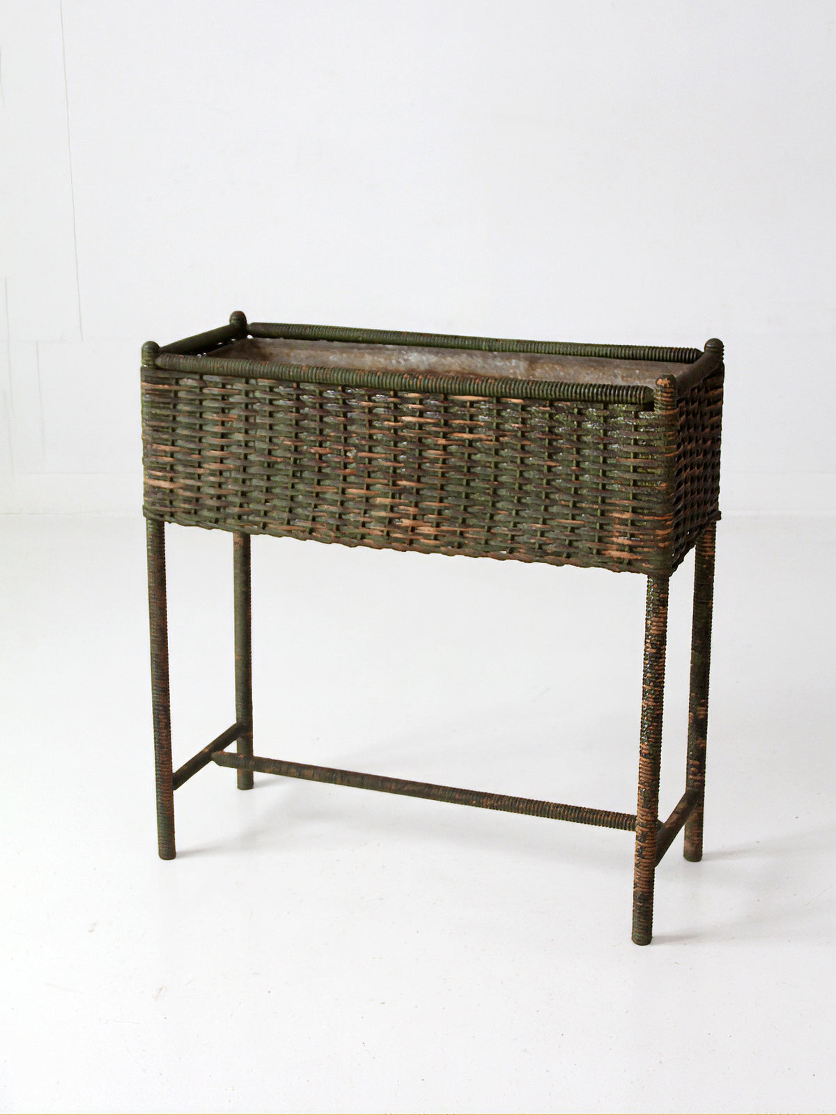 antique green painted wicker jardinière planter with metal liner