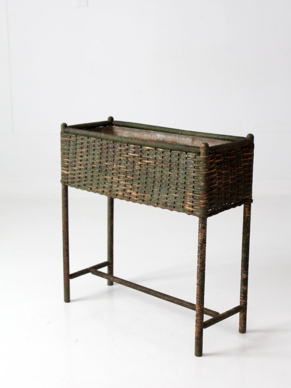 antique green painted wicker jardinière planter with metal liner