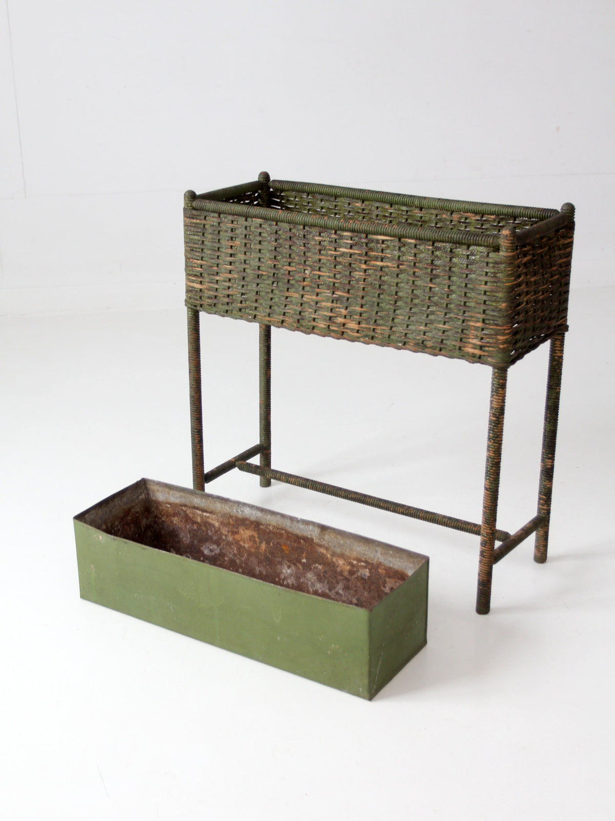 antique green painted wicker jardinière planter with metal liner