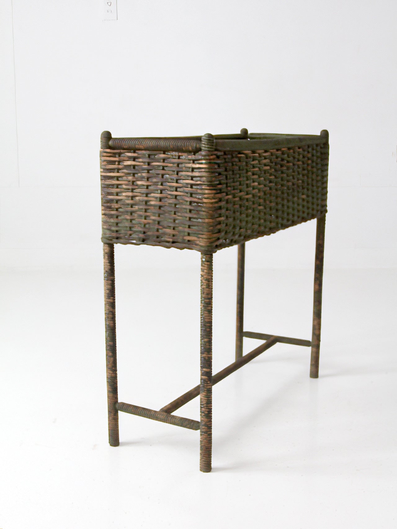 antique green painted wicker jardinière planter with metal liner