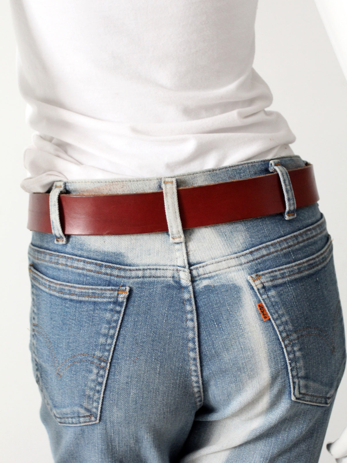 vintage leather belt with sculptural brass hook buckle