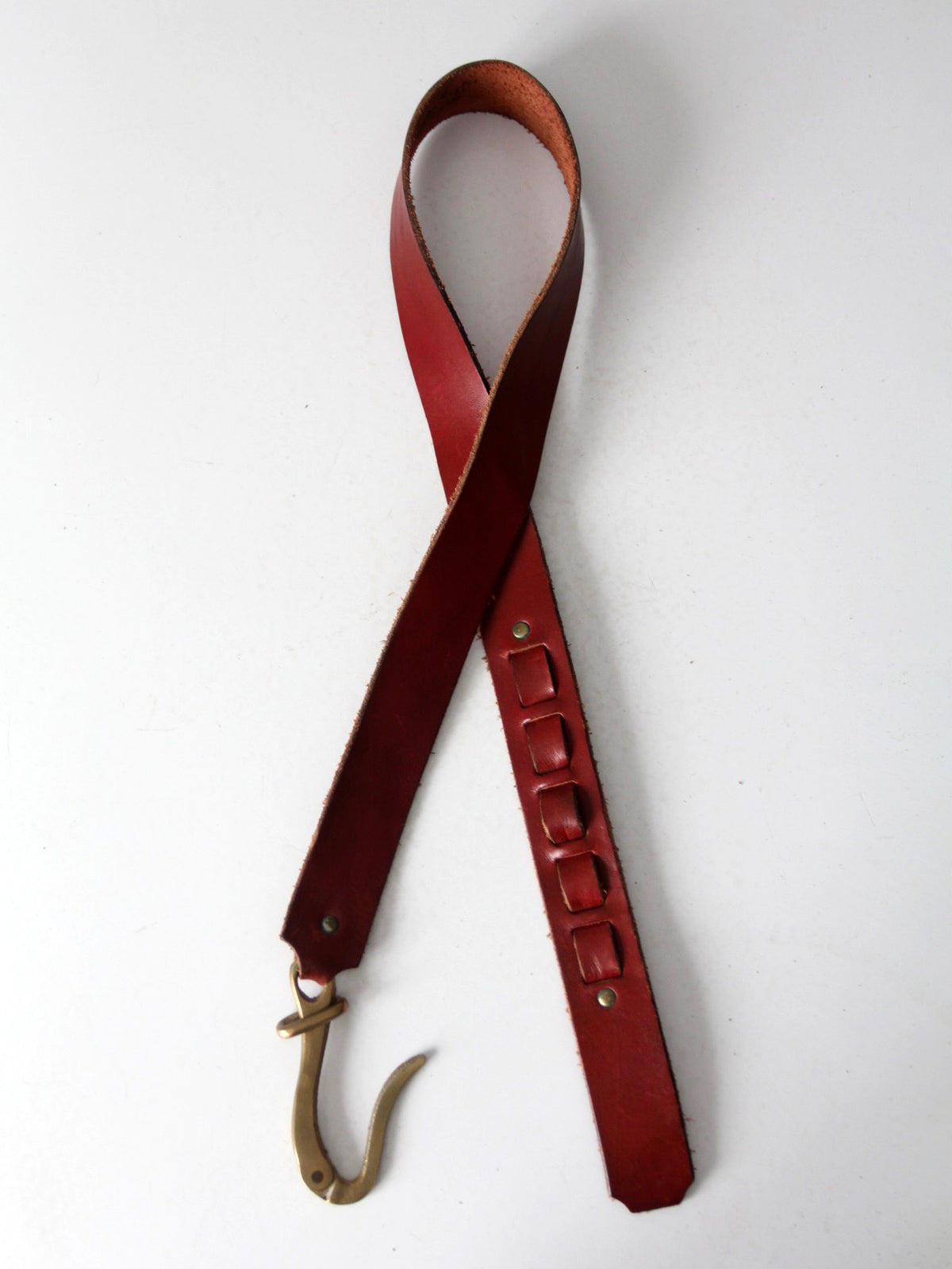 vintage leather belt with sculptural brass hook buckle