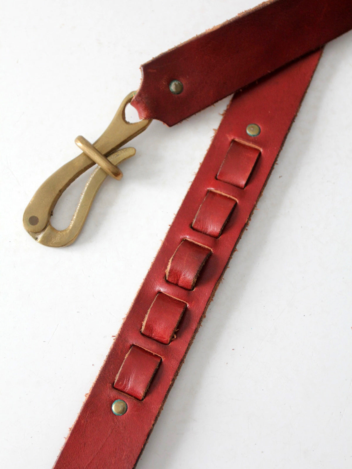 vintage leather belt with sculptural brass hook buckle