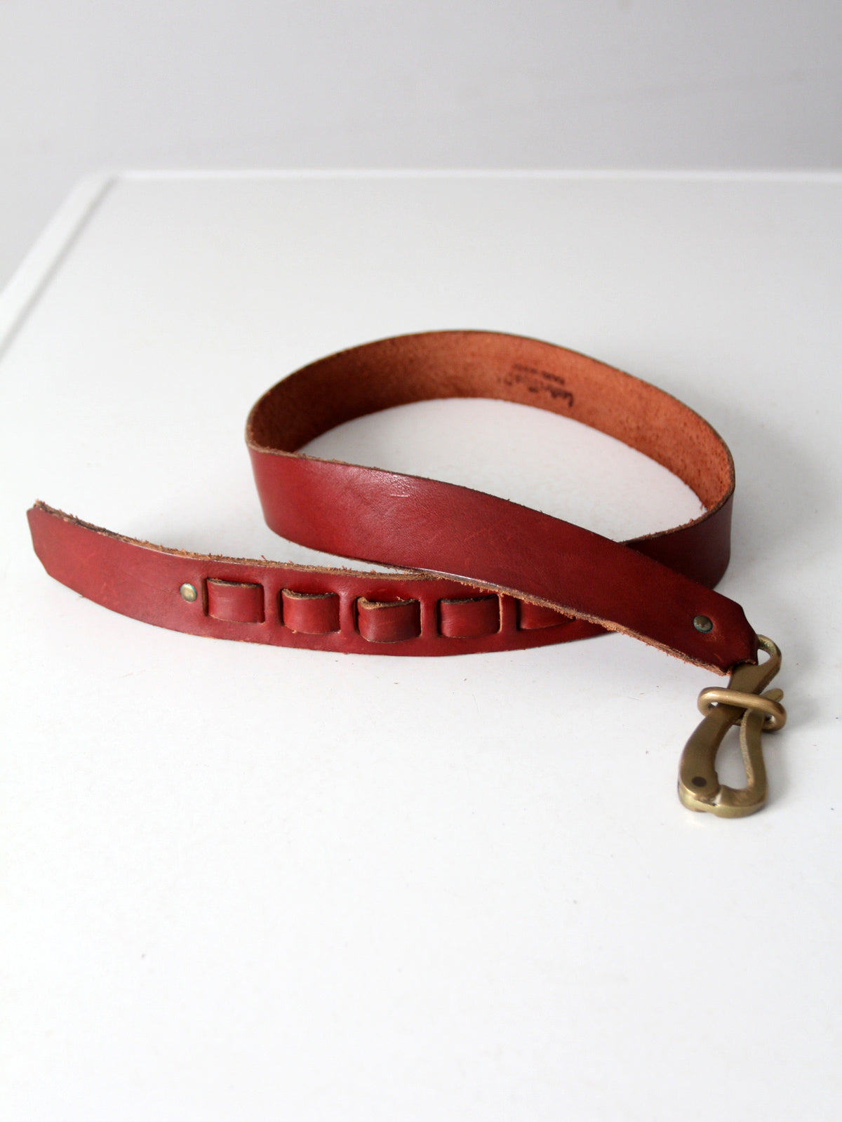 vintage leather belt with sculptural brass hook buckle