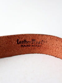vintage leather belt with sculptural brass hook buckle