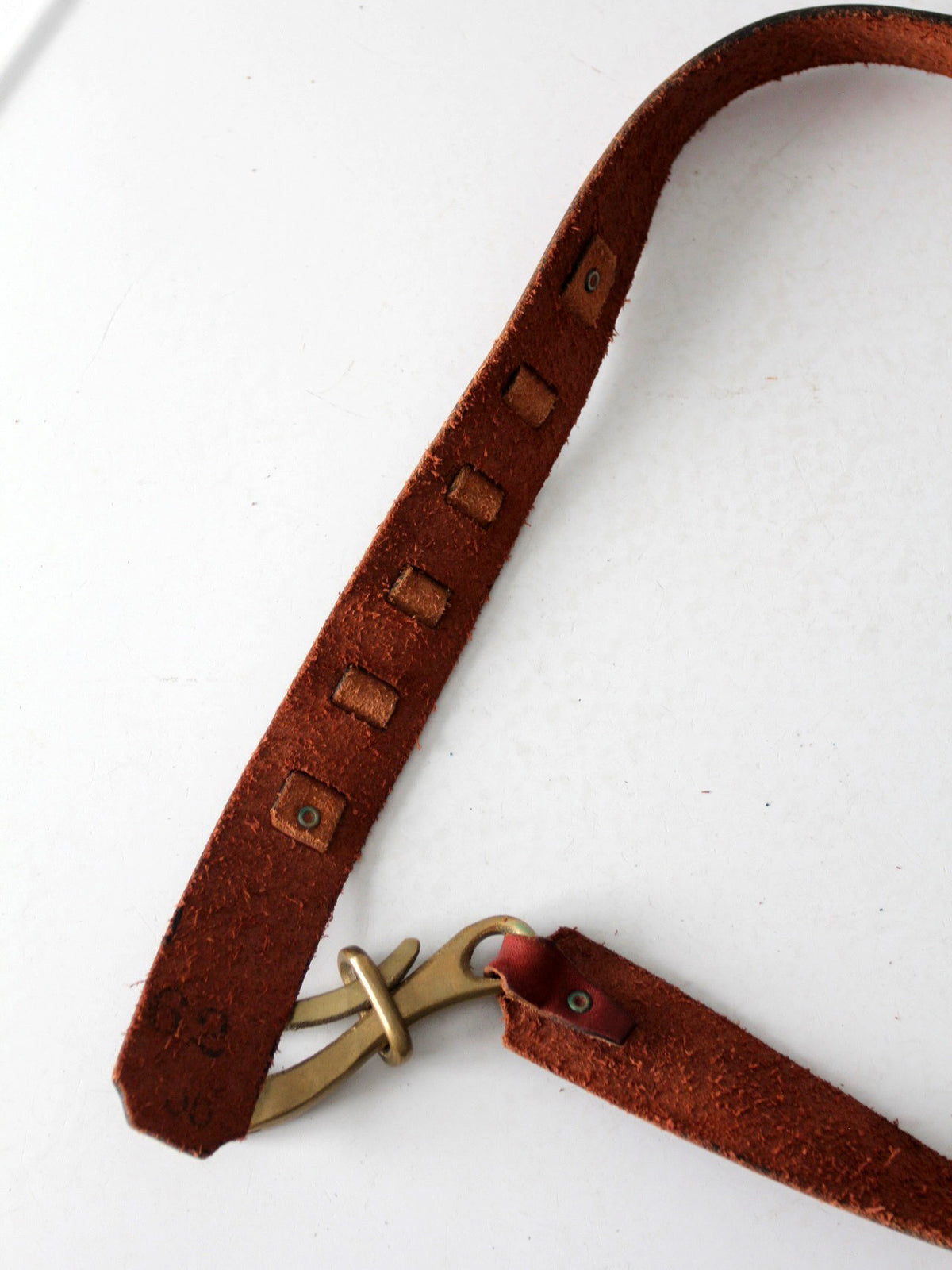 vintage leather belt with sculptural brass hook buckle