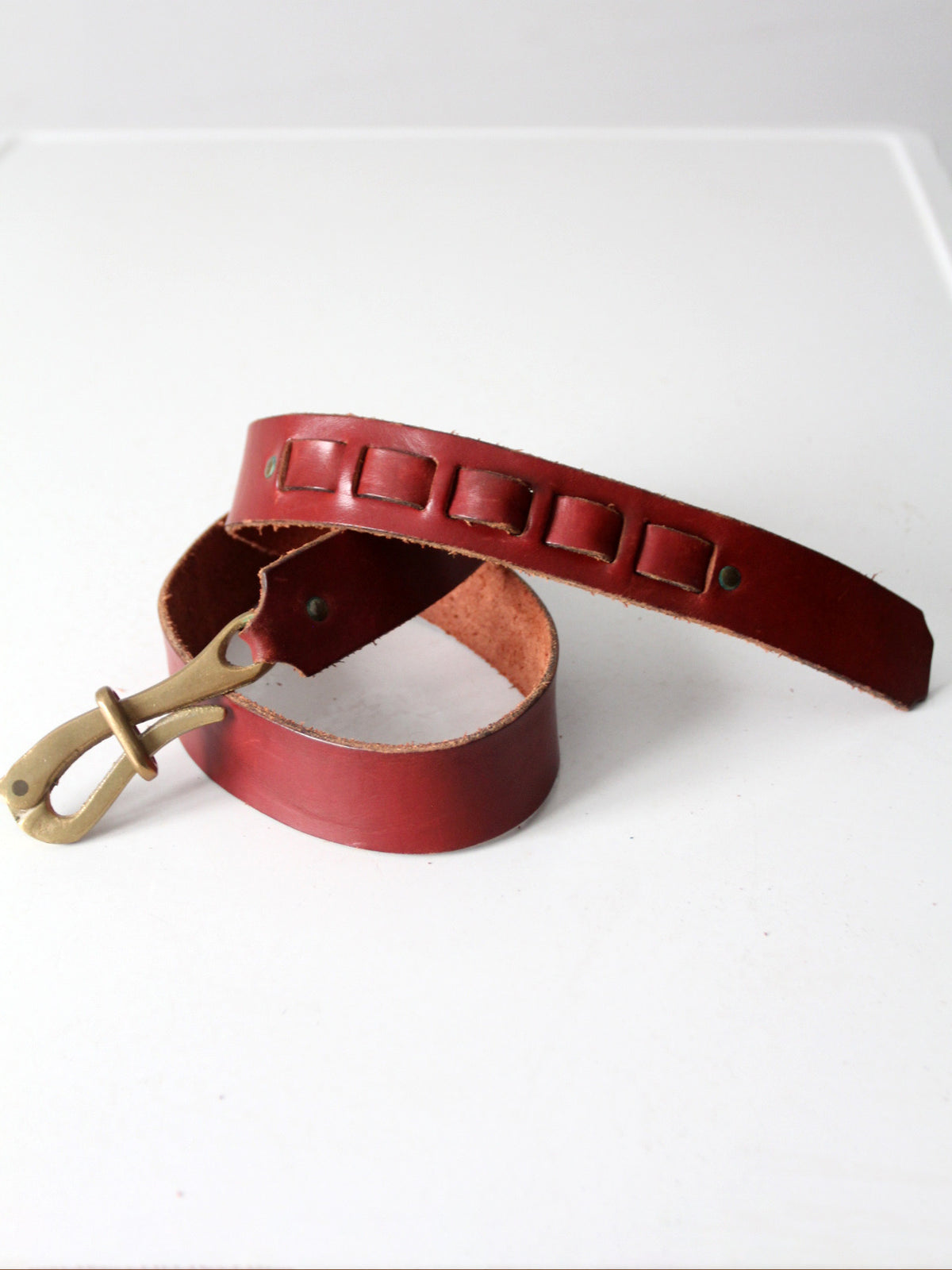vintage leather belt with sculptural brass hook buckle