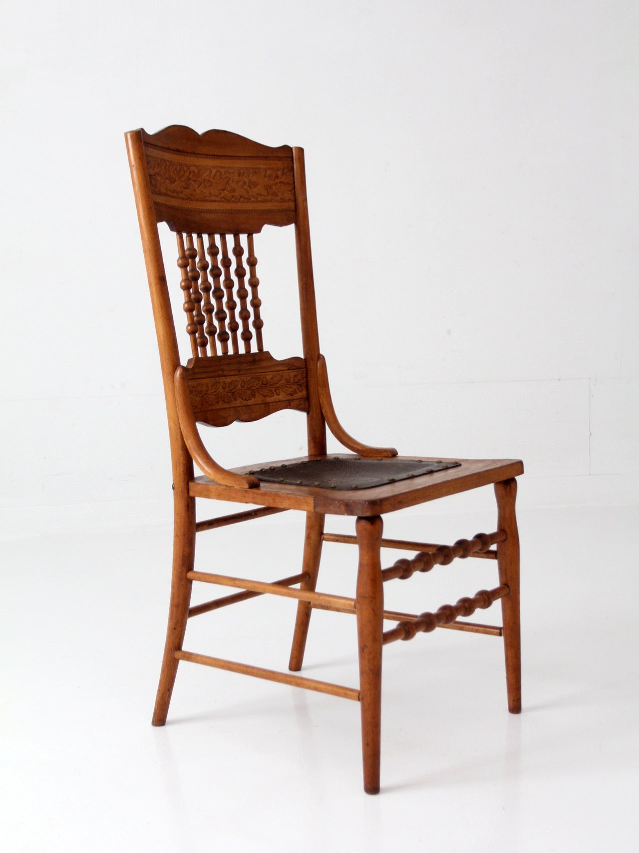 antique Victorian Eastlake chair with embossed leather seat