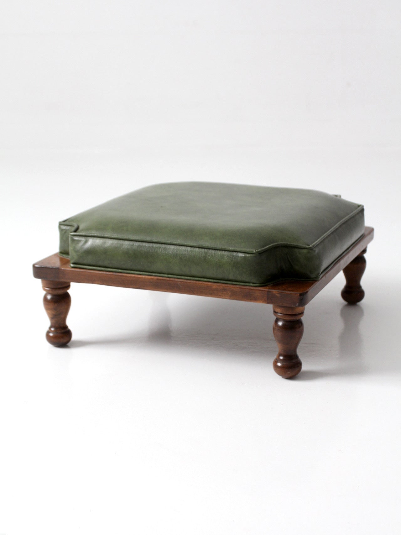 mid-century Colonial Revival footstool with green cushion
