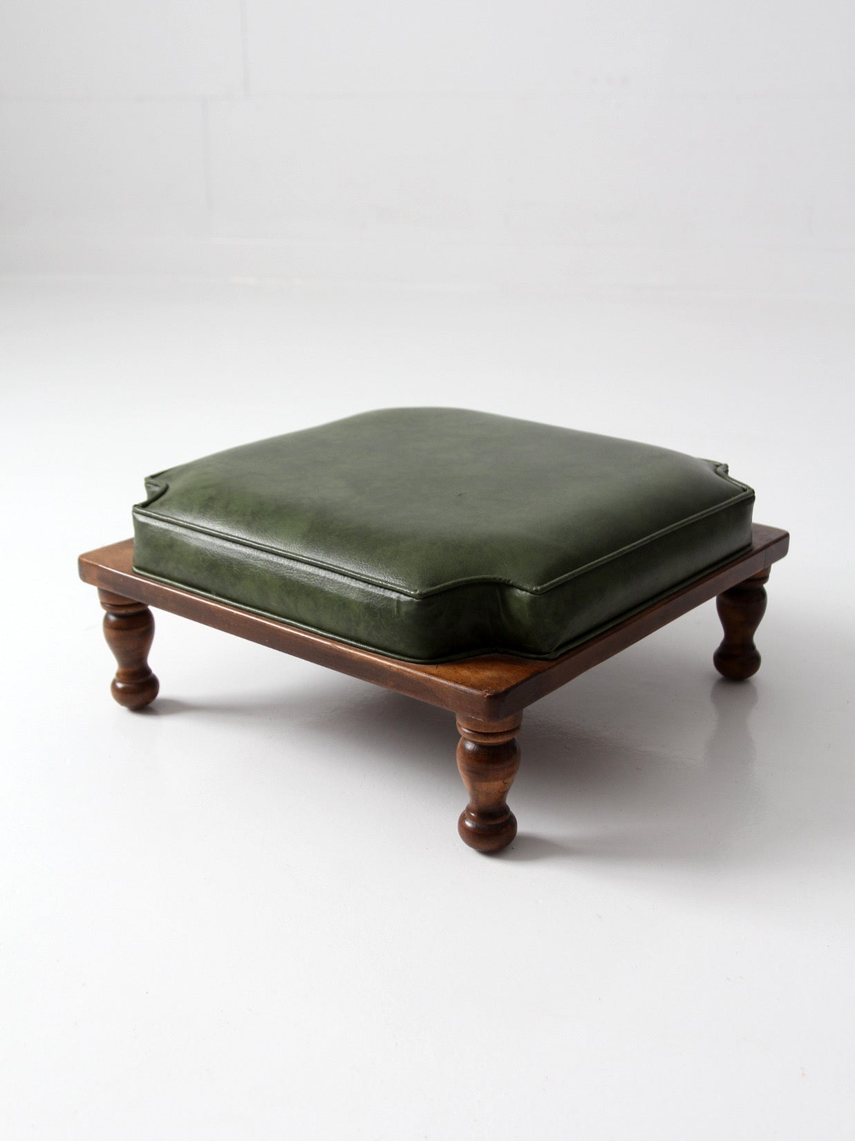 mid-century Colonial Revival footstool with green cushion
