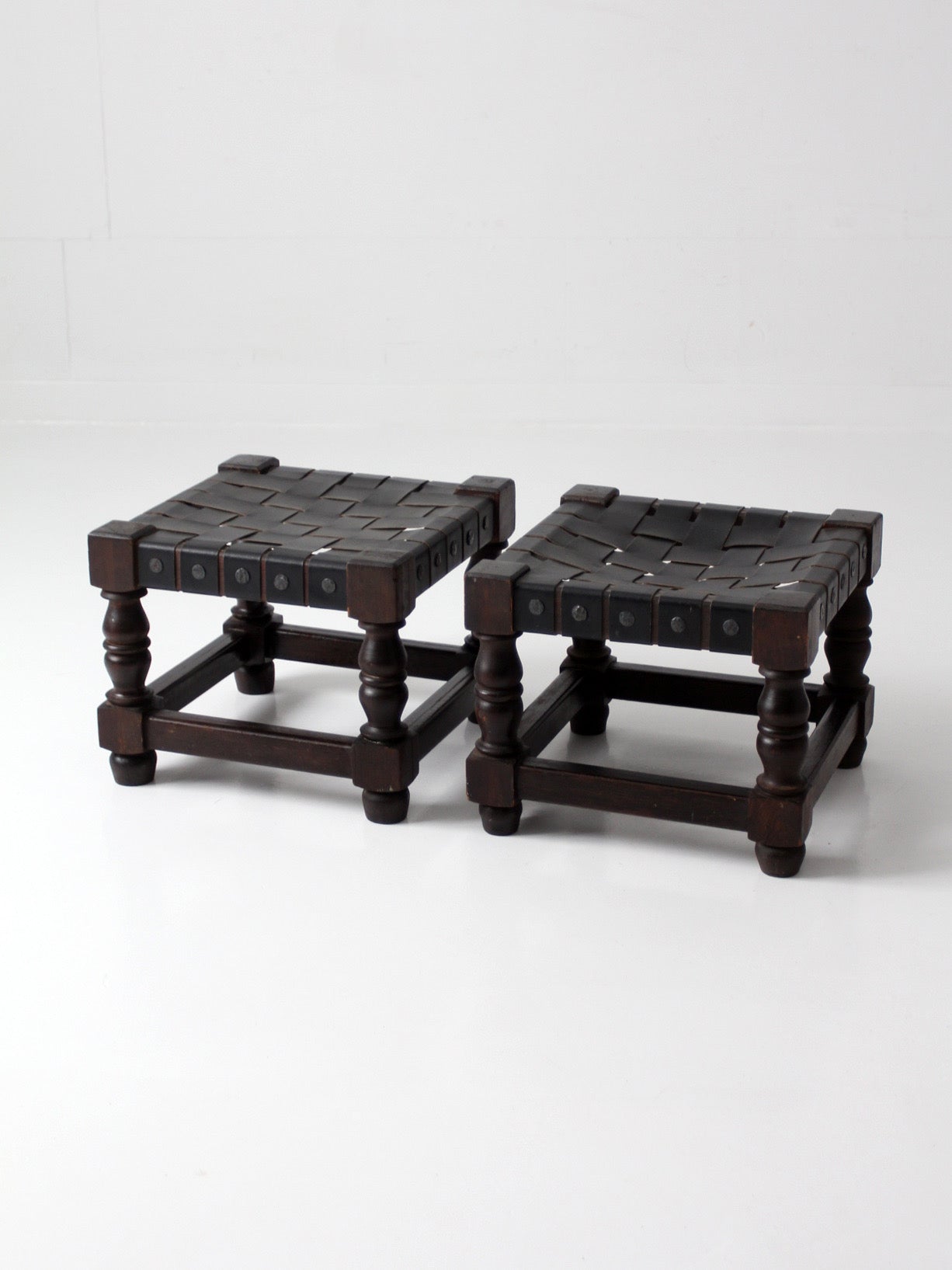 mid-century Spanish Revival leather strap stools pair